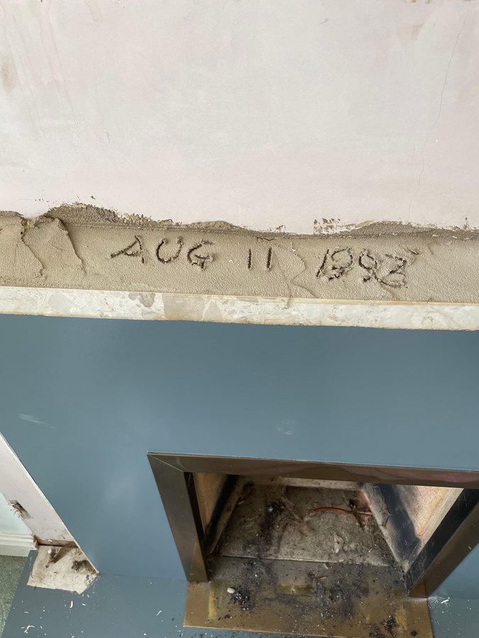 A mortar bed above a fireplace lintel with the date August 11 1993 scratched into it by a previous tradesman